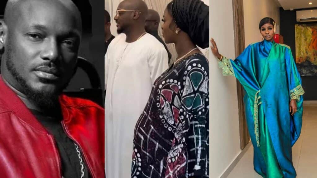 Bold young man in a red leather jacket looking at the camera at a fashion or cultural event.