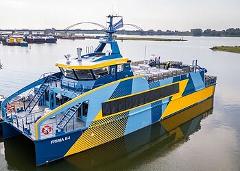 FRISIA E-1 electric ferry docked at harbour, eco-friendly maritime transport, sustainable ferry boat in service, innovative electric vessel, environmental shipping technology, green transportation.