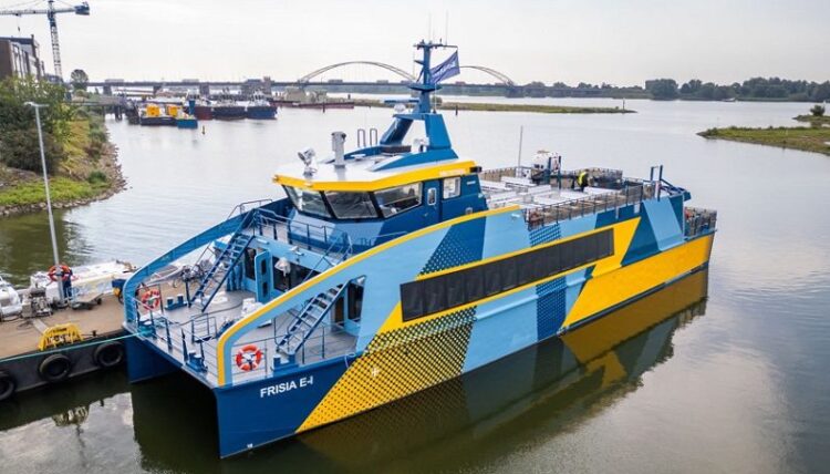 FRISIA E-1 electric ferry docked at harbour, eco-friendly maritime transport, sustainable ferry boat in service, innovative electric vessel, environmental shipping technology, green transportation.