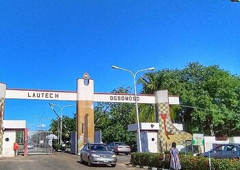 Lautech Ogbomoso university entrance gate in Nigeria under a clear blue sky with surrounding greenery.