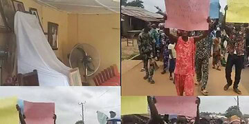 Empty conference room with draped white cloth and standing fan, symbolising event preparations.