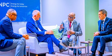 Innovative energy leaders engaging in a strategic discussion at a professional conference, emphasising renewable energy and global sustainability initiatives.