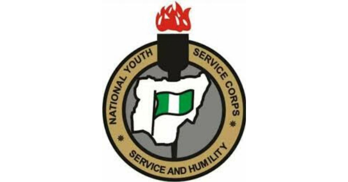 NATIONAL YOUTH SERVICE CORPS emblem featuring a raised fist with Nigerian and Irish flags and a flaming torch symbolising service, humility, and youth empowerment.
