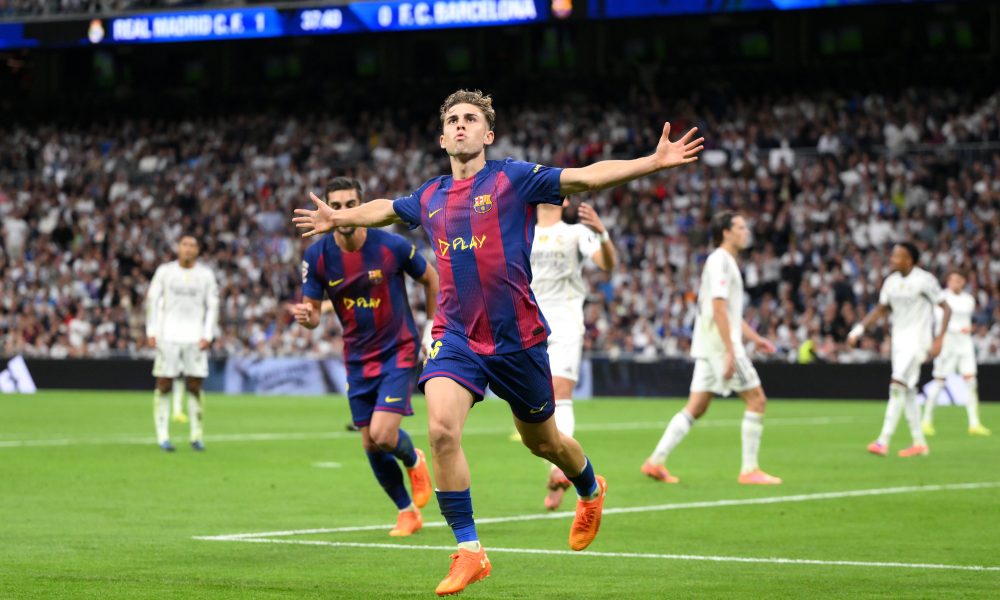 Spectacular football goal celebration during a live match at Real Madrid C.F. versus FC Barcelona, showcasing passionate players and intense stadium atmosphere, perfect for football fans.
