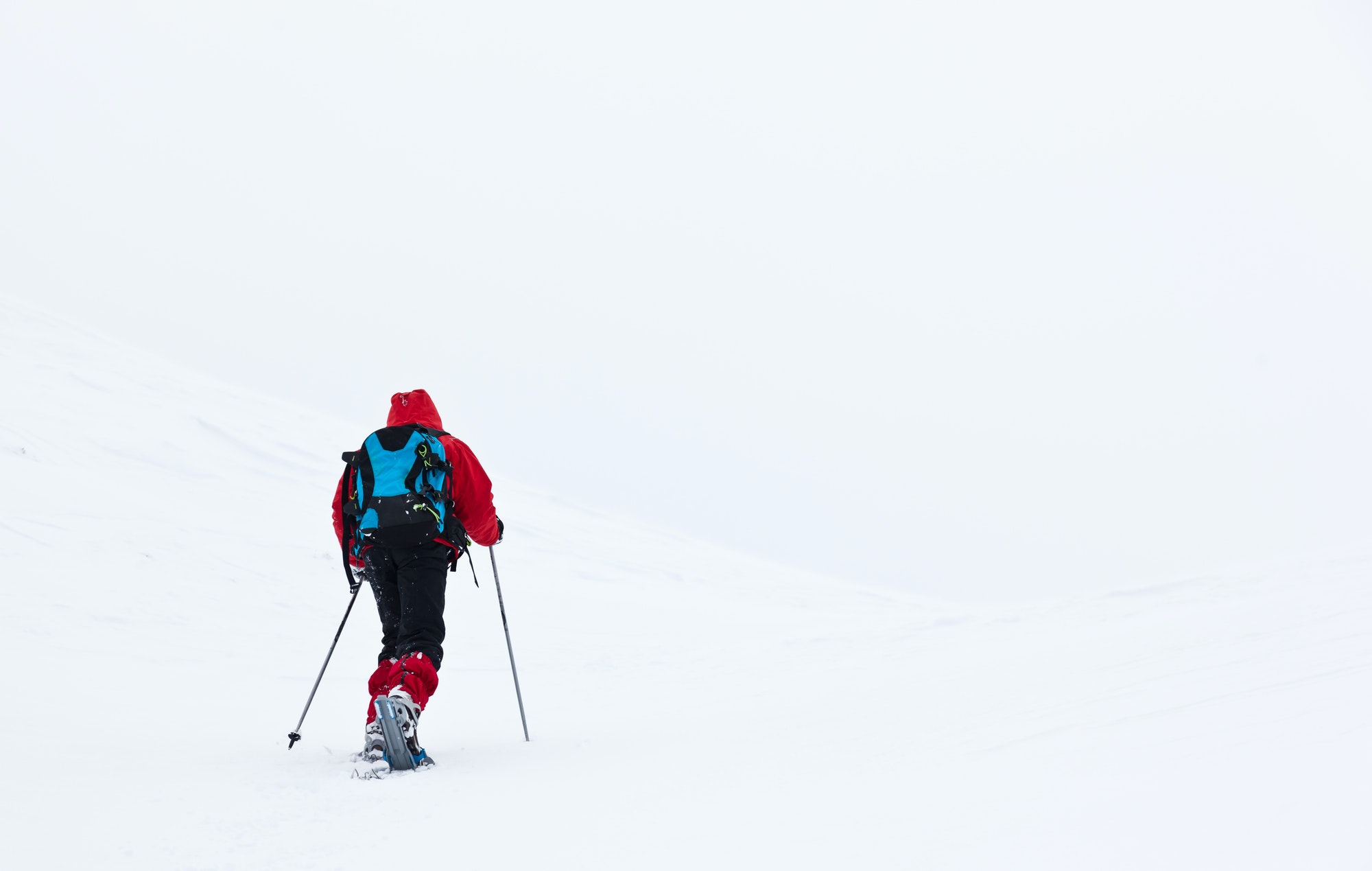 Boy hikes in mountain with snowshoe