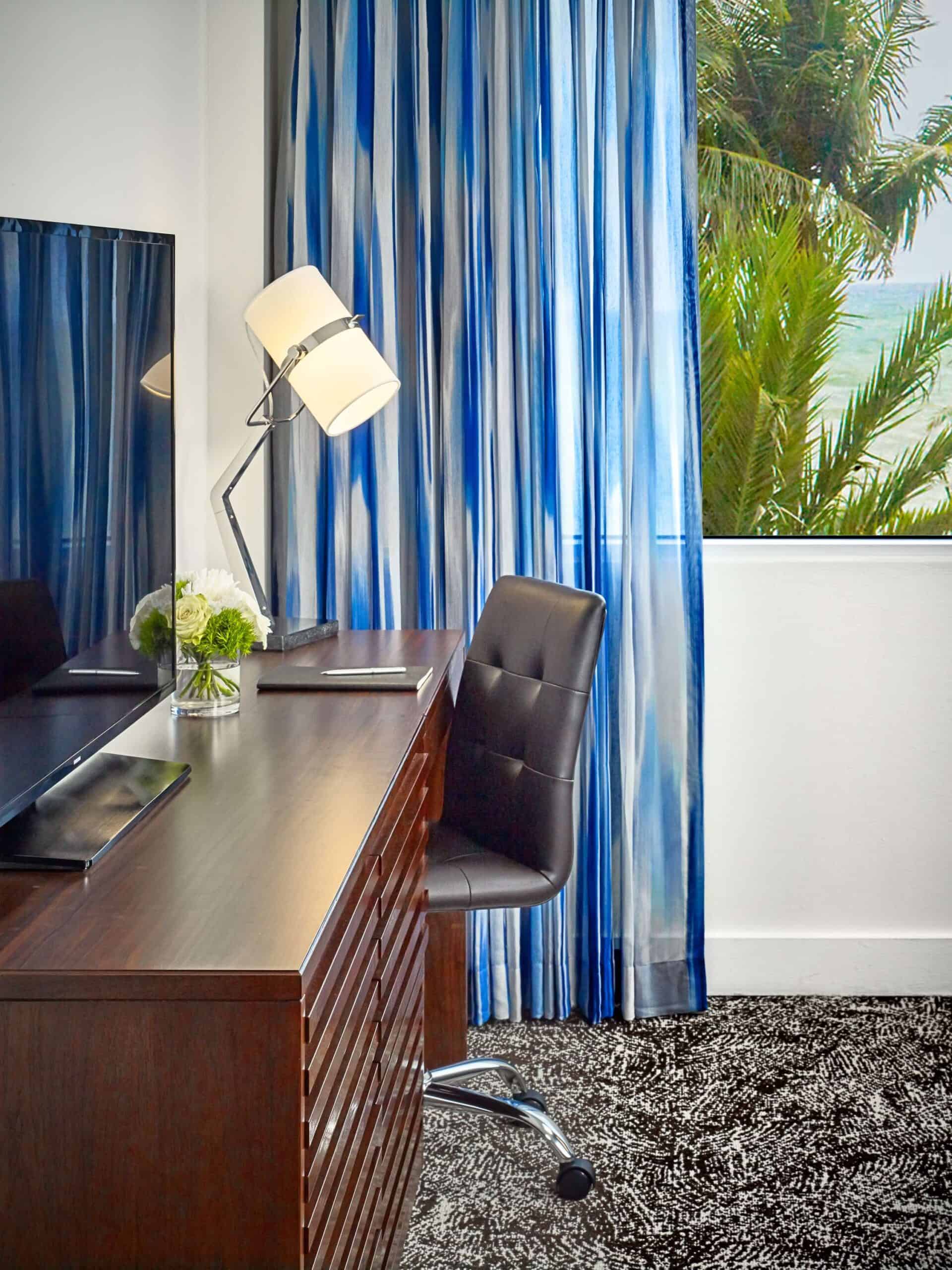 Hotel guestroom work area with a TV.