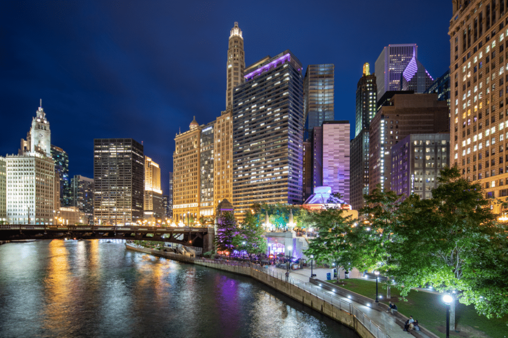 Night view of city skyline along riverfront.