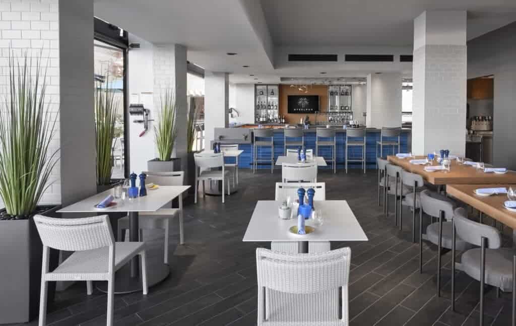 Modern restaurant interior with neatly set tables.