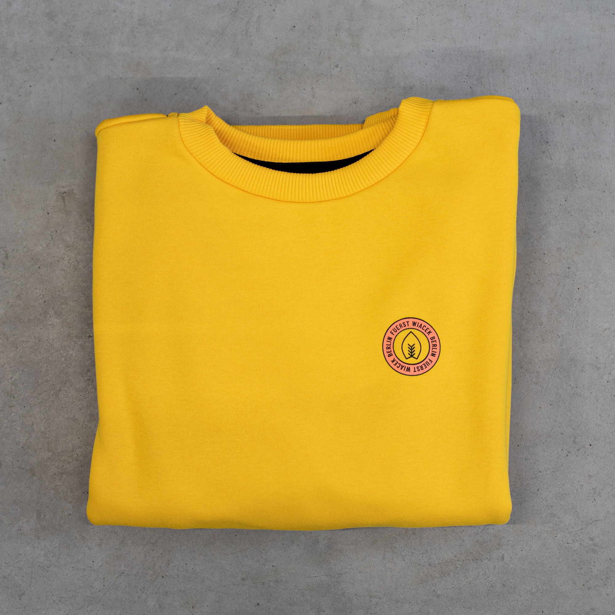 Fuerst Wiacek Brewery yellow sweatshirt with logo, casual apparel, brewery merchandise, craft beer branding, comfortable clothing for beer enthusiasts.
