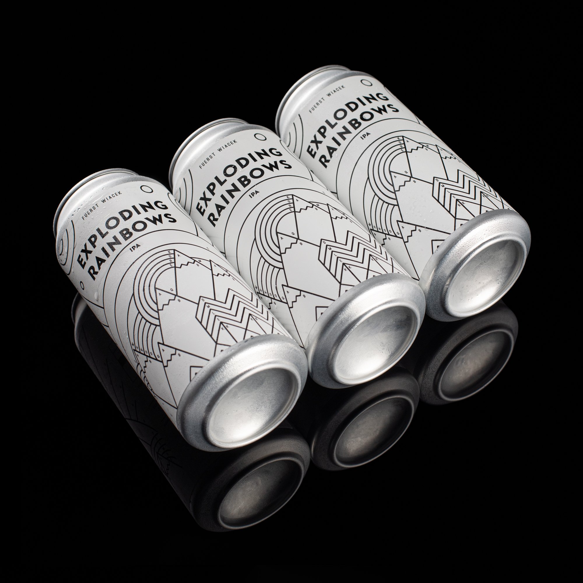 Minimalist white beer cans with black line art design displaying "Exploding Rainbows" IPA by Fuerst Wiacek Brewery, set against a black reflective surface for a sleek, modern aesthetic.