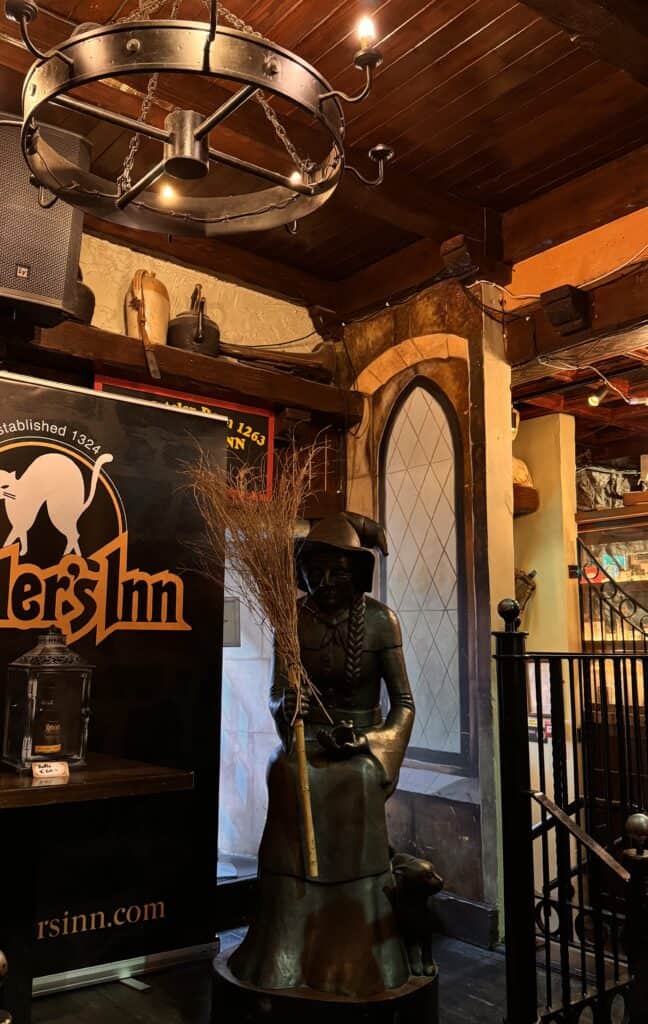 Statue of a woman holding broom