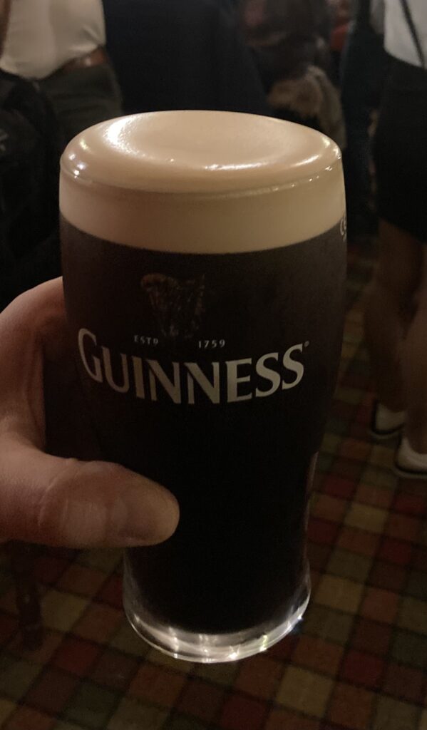 Hand holding a pint of Guinness