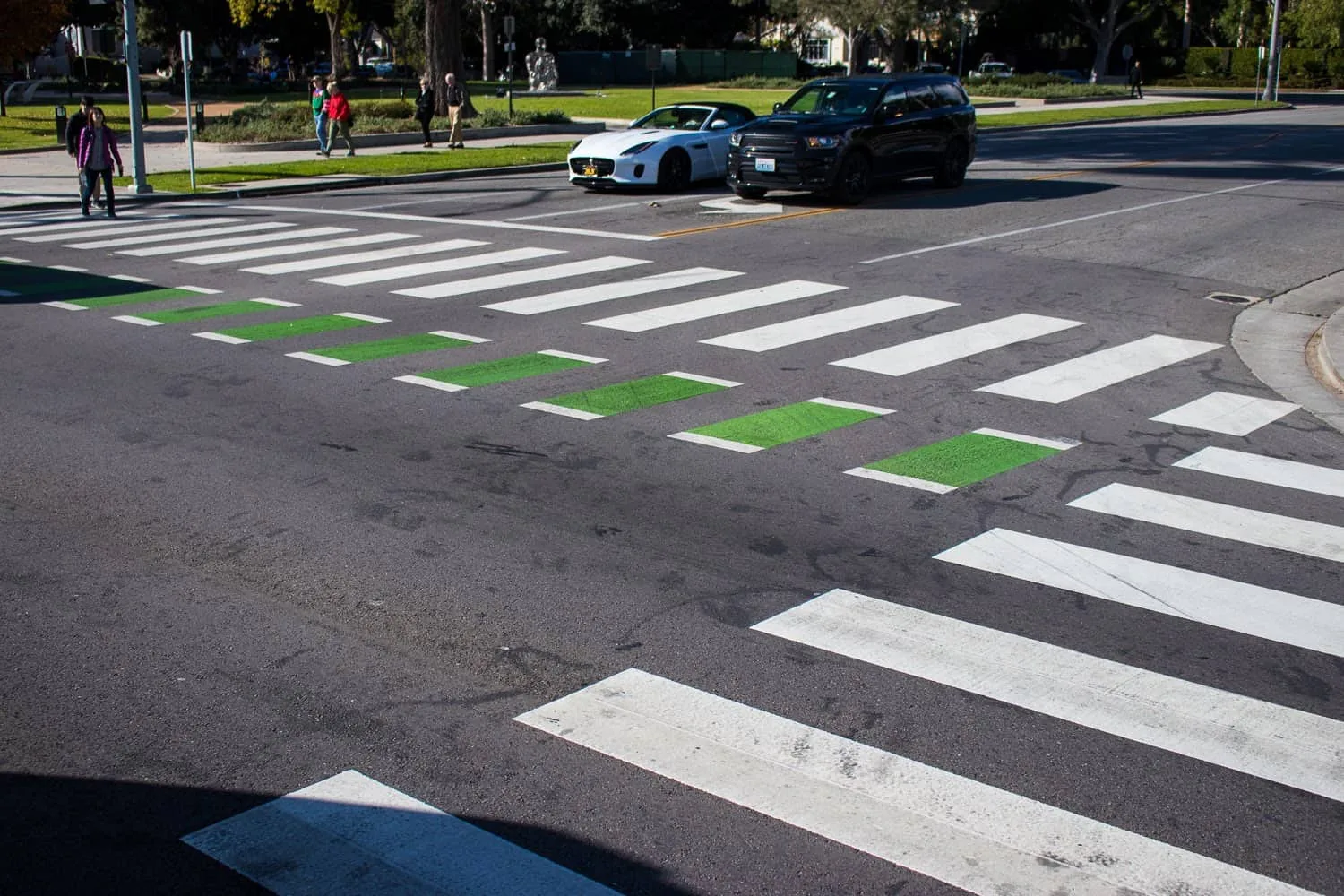 Pedestrian crosswalk at a busy Boston intersection with approaching vehicles