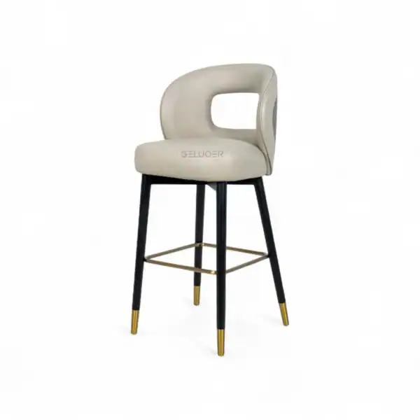 Elegant modern bar stool with beige cushioned seat and black gold-accented legs, perfect for stylish home bars or kitchens.