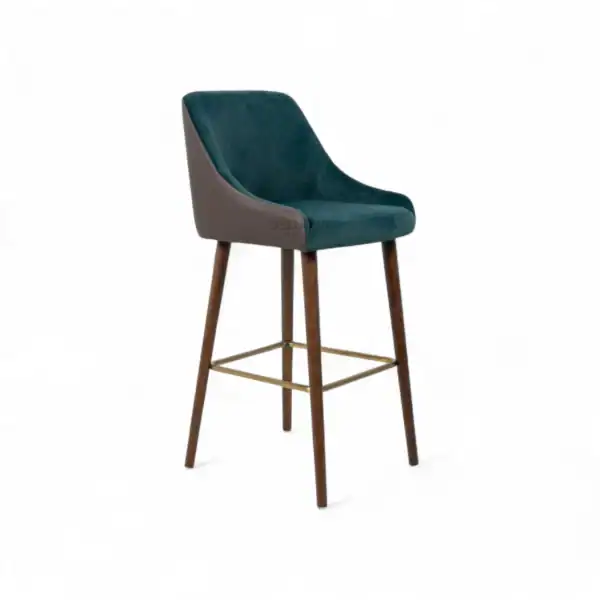 Luxurious teal velvet bar stool with wooden legs and metallic footrest for modern home decor.