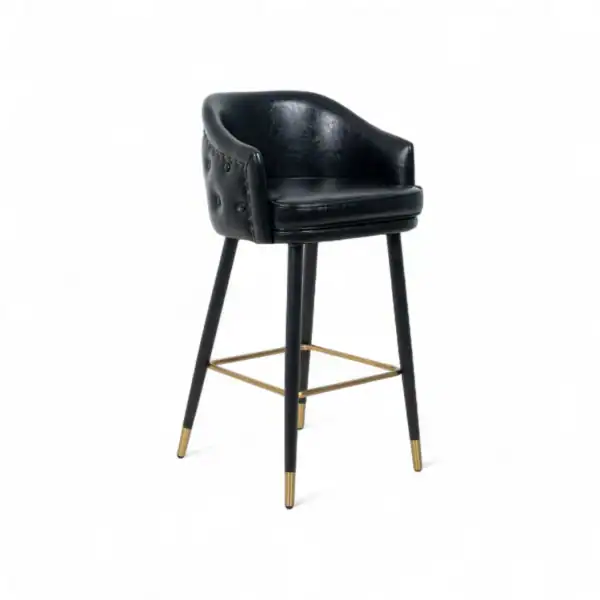 Black leather bar stool with wooden legs and gold footrest, modern furniture design.