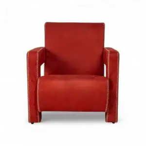 Elegant red leather armchair with nailhead trim for modern living room decor.