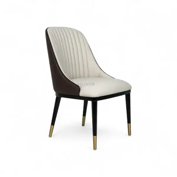 Elegant modern dining chair with cream and dark brown upholstery, gold-tipped black wooden legs.