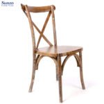 Rustic wooden dining chair with distressed finish, ideal for vintage or farmhouse decor.