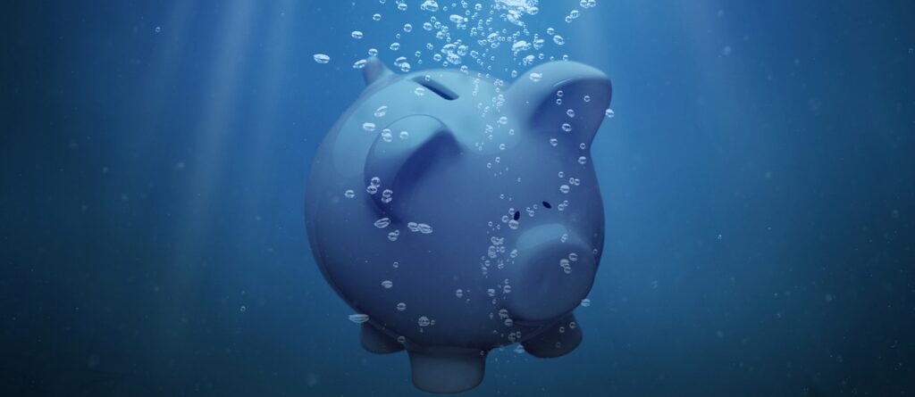 Piggy bank underwater with bubbles, symbolising savings and financial growth.