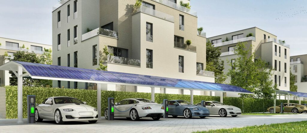 Electric vehicle charging station with multiple cars parked under a modern residential building in A.