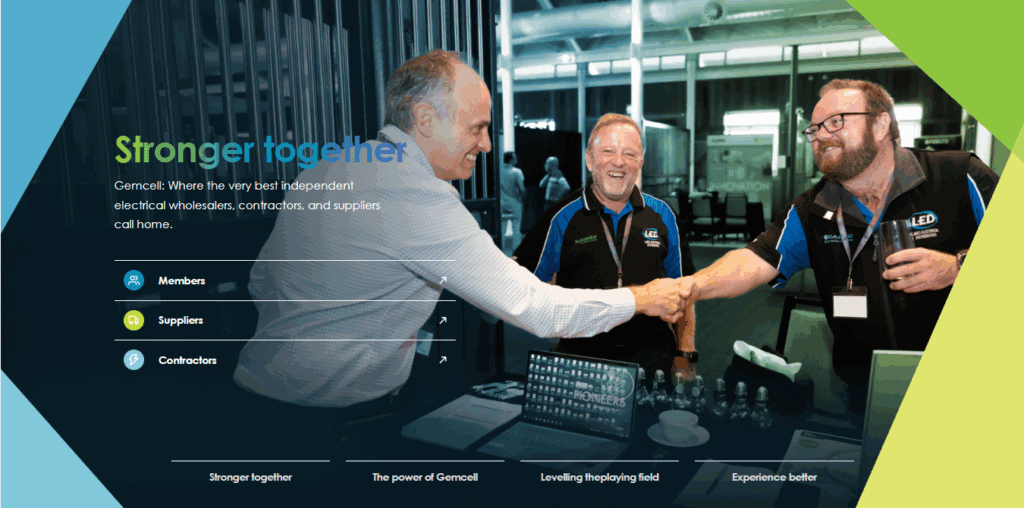 Business professionals at Gemcell trade show booth shaking hands and networking.