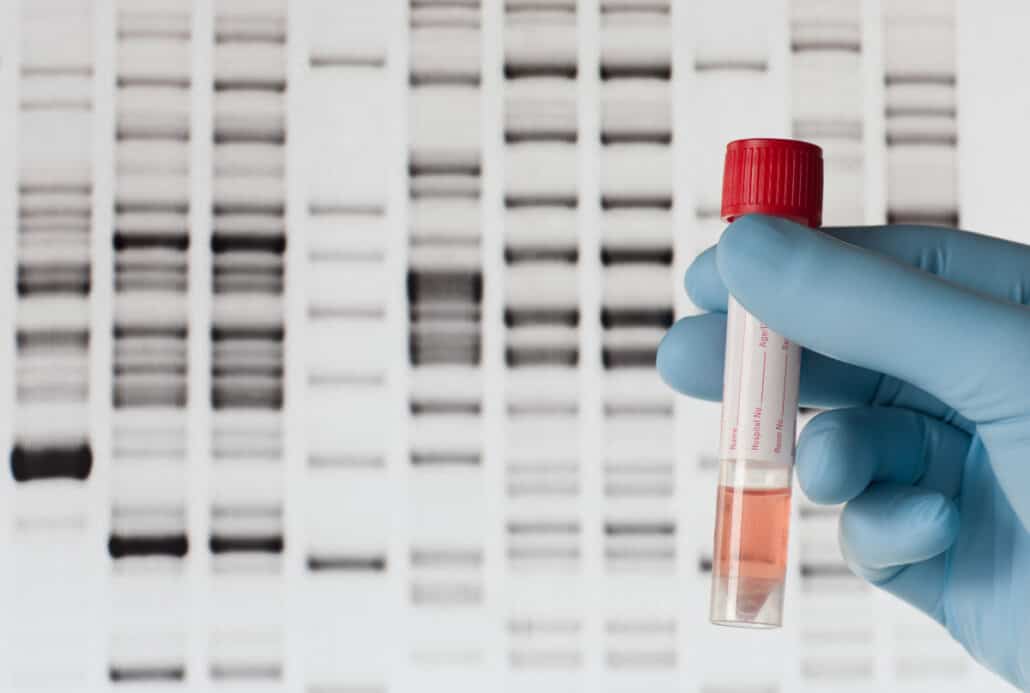 test tube vile in front of dna chart