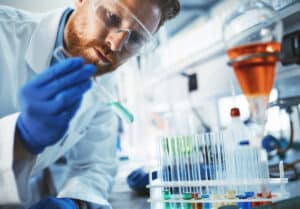 lab technician looking at test tube
