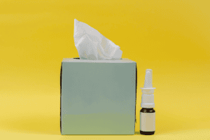 tissue box and nasal spray signify allergies and depression