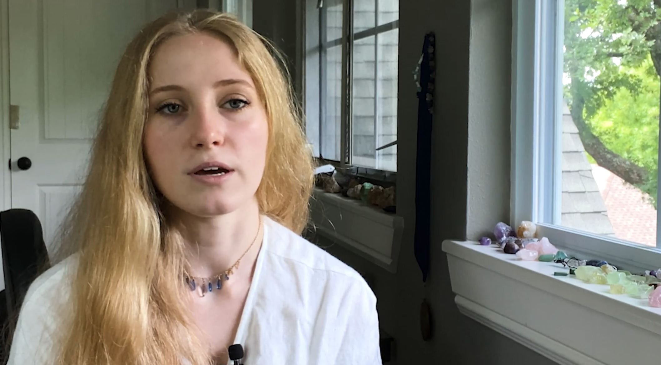thumbnail of Genomind patient testimonial video of Caitlin speaking sitting down next to window
