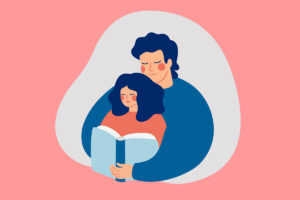 father reading book to daughter
