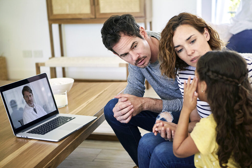 mother and father seated talking to daughter about testing