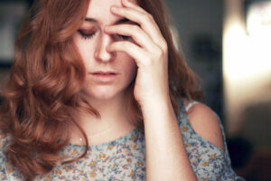 portrait of girl with her hand over one eye