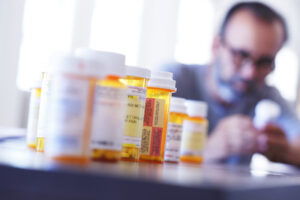 pill bottles with man in background