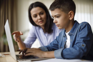 woman and little boy sitting at computer
