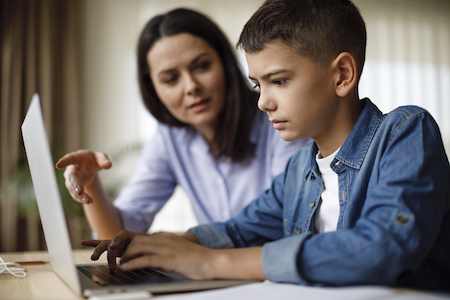 woman and little boy sitting at computer