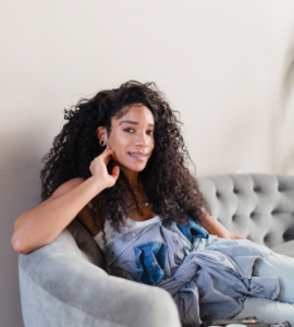 woman sitting on couch with arm propped up