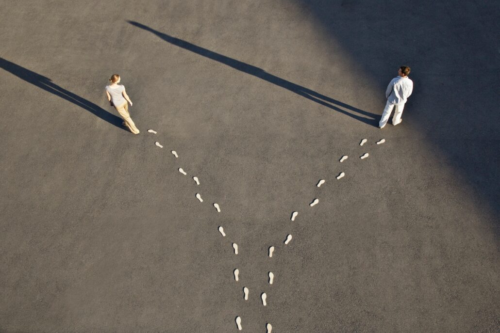 two people walking different paths