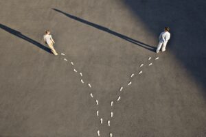 two people walking different paths