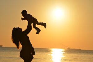 mother holding child high above head