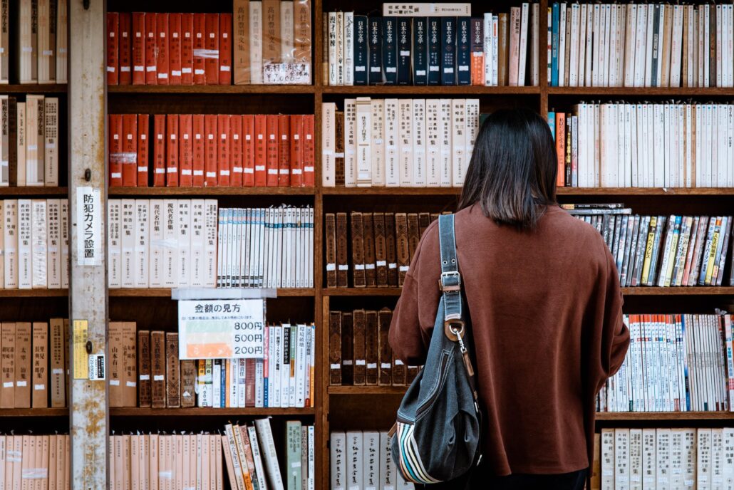 woman standing in front of bookshelf