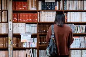 woman standing in front of bookshelf