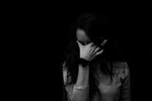 girl putting hand over eyes