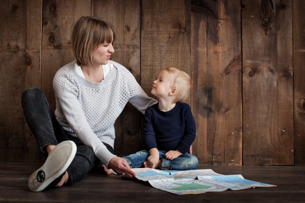 woman sitting with son looking at map