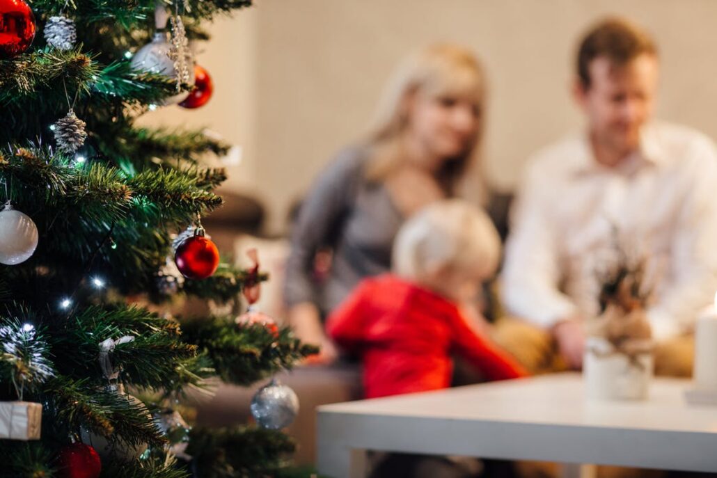 Christmas tree with family in background