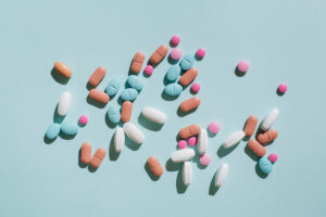 multi-color pills scattered on blue surface for treating multiple comorbidities