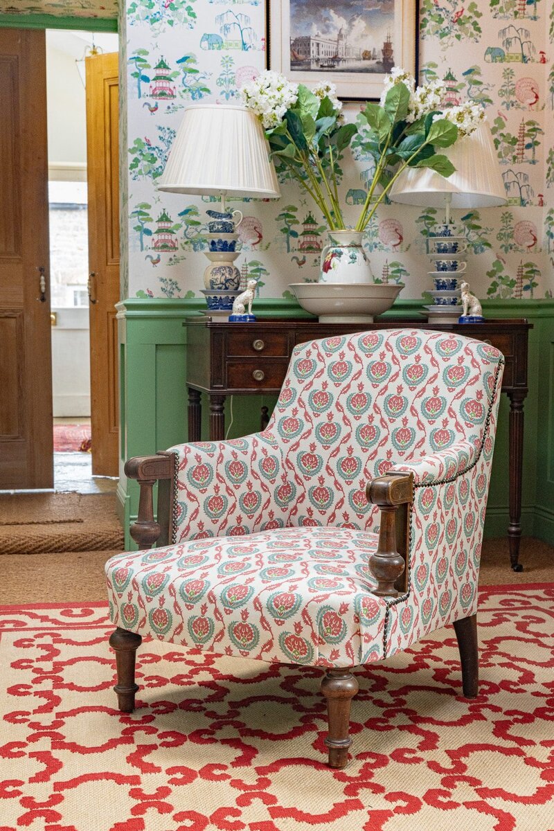 An upholstered fabric chair in a hallway designed by Charlotte Gaisford and photographed by Georgie Greene Photography as part of Business Branding for Charlotte's design business