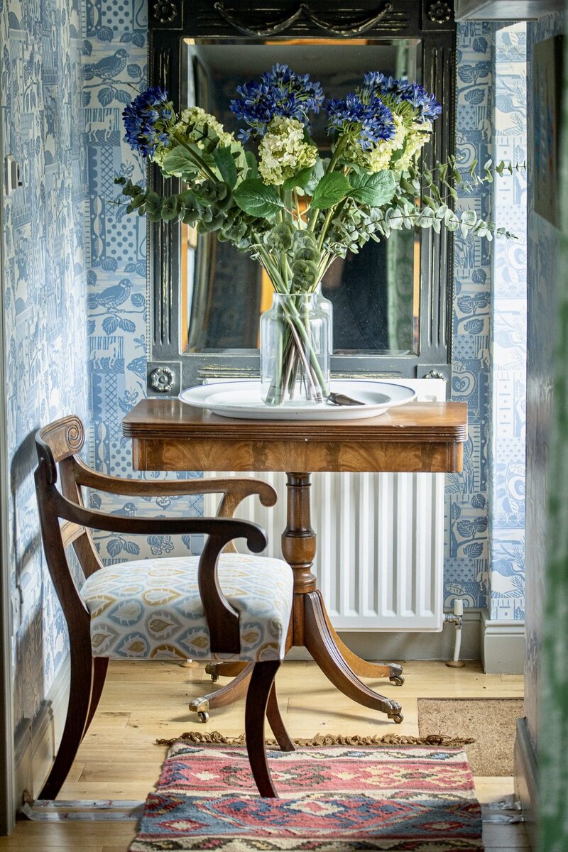 Corridor with a chair and vase of flowers at Charlotte Gaisford home taken by Georgie Greene Photography for her personal branding shoot