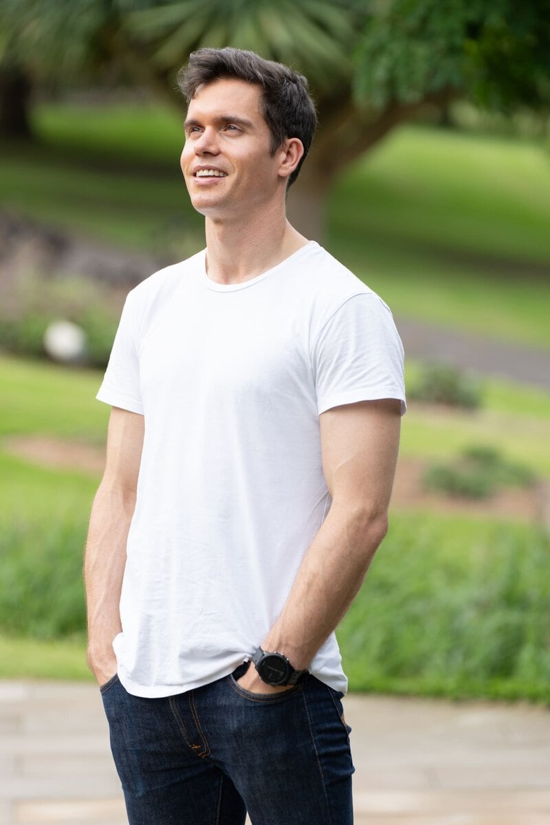 Ext: Young man wearing a white t-shirt having a dating profile photo taken by dating app photographer Georgie Greene in Sydney NSW