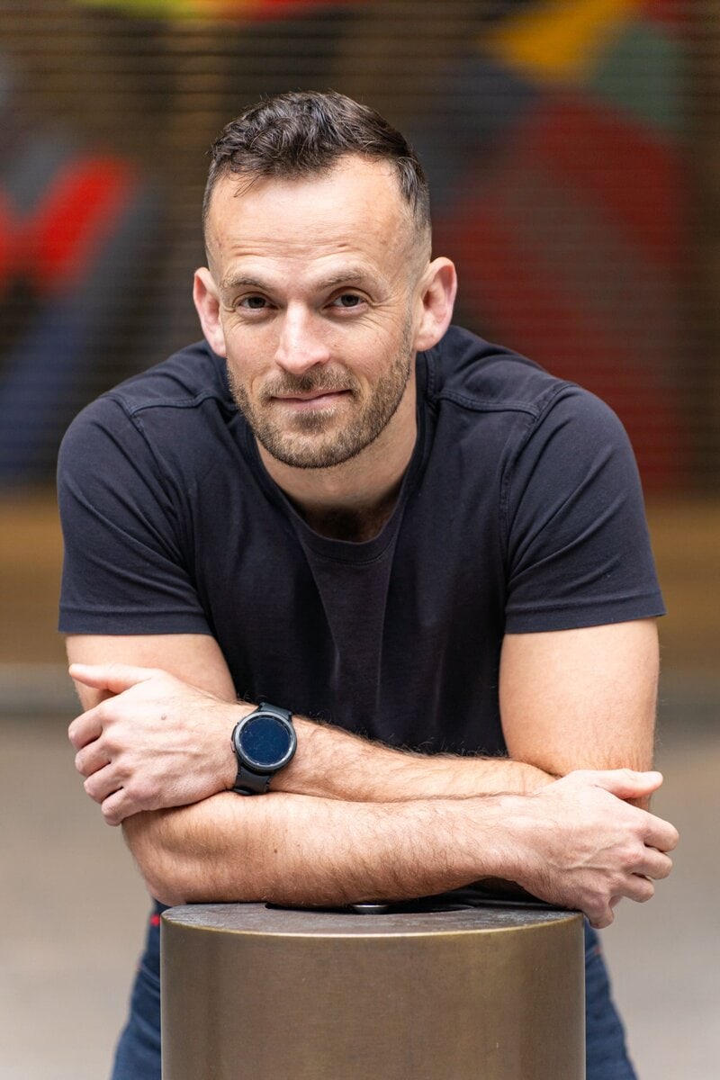 Ext: Young man wearing a black shirt having a dating profile photoshoot with professional photographer Georgie Greene in Sydney NSW